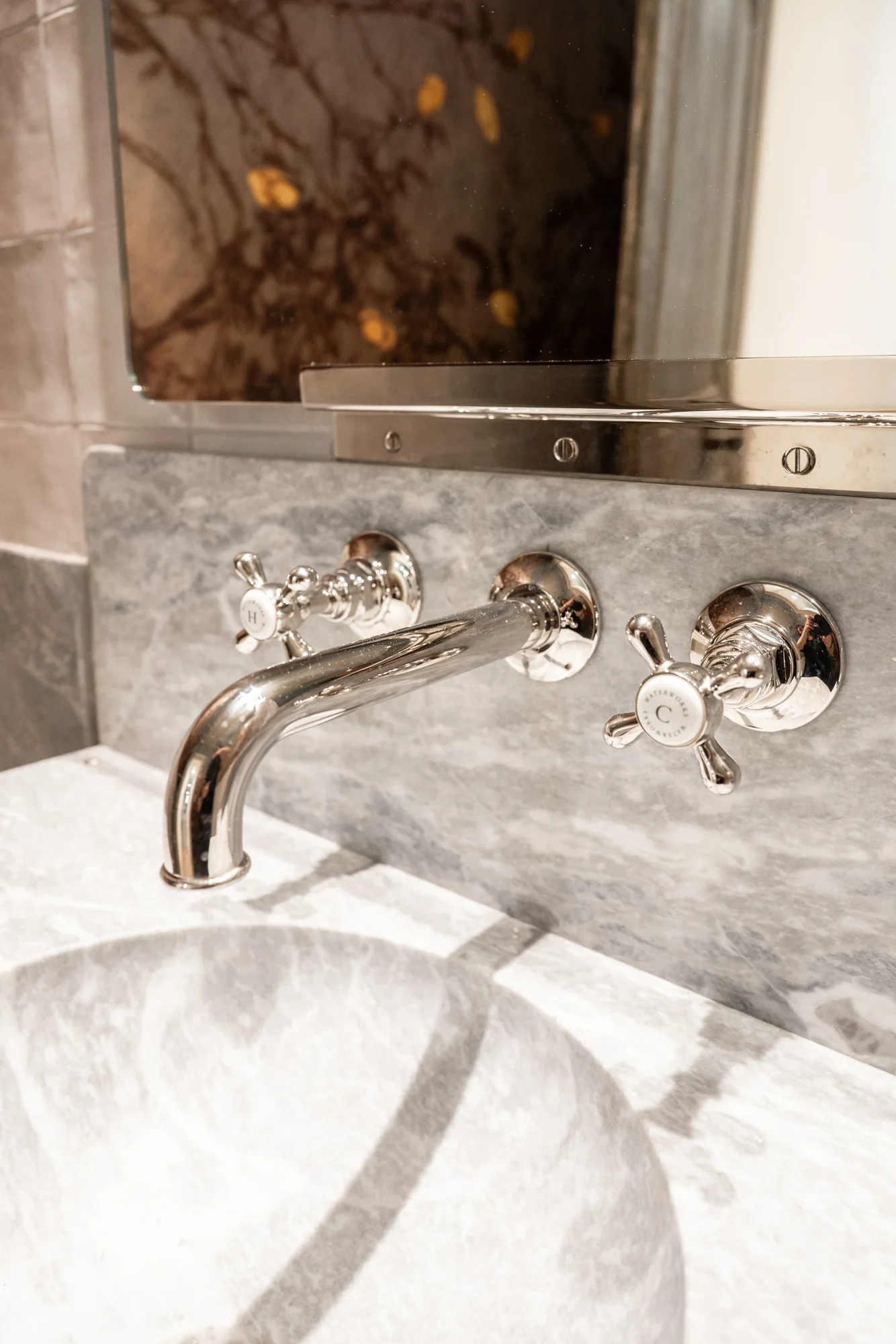 A sculpted stone basin with expressive veining