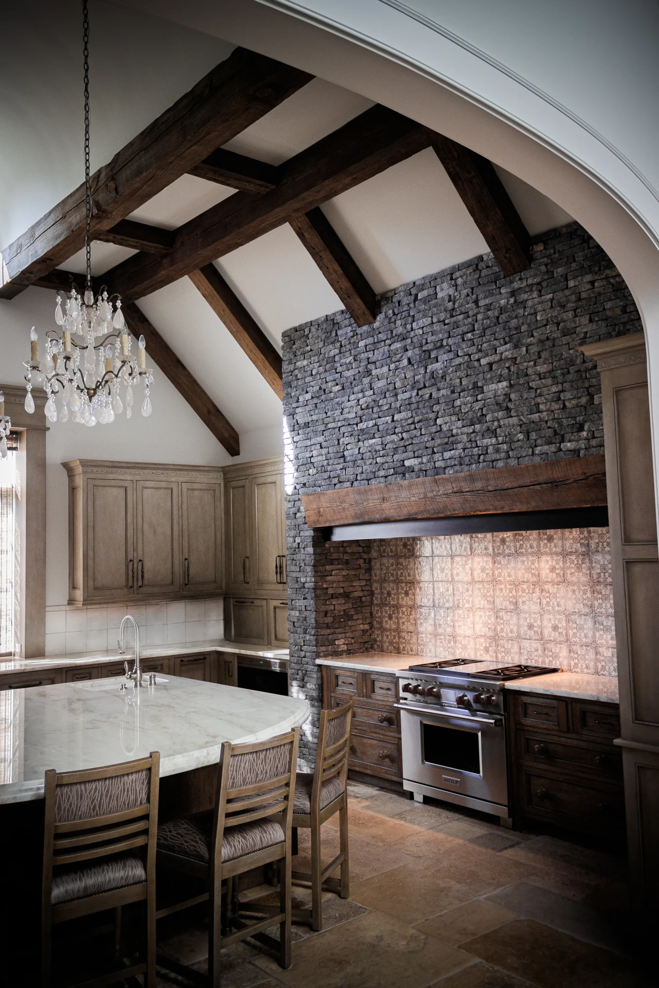 Timber cabinetry and a pale stone island in the Equestrian Estate kitchen